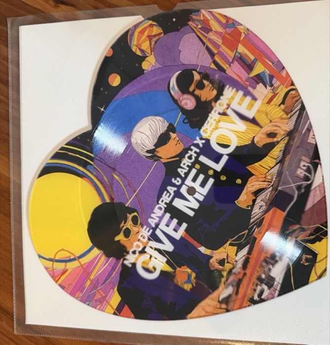The actual heart-shaped Give Me Love vinyl